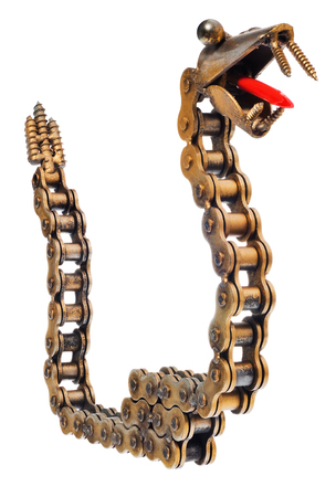 Handmade mechanic decorative snake. Reptile made of motorcycle parts: chain, bearings, screws. Artistic object painted on gold isolated on a white background.の写真素材