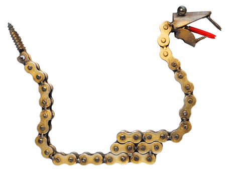 Handmade mechanic decorative snake. Reptile made of motorcycle parts: chain, bearings, screws. Artistic object painted on gold isolated on a white background.の写真素材