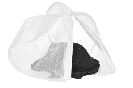 Wash bag for delicate clothes, shoes, underwear, bra. A laundry bag made of white mesh filled bras, isolated on a white background.の写真素材