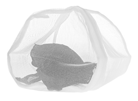 Wash bag for delicate clothes, shoes, underwear, bra. A laundry bag made of white mesh filled bras, isolated on a white background.の写真素材