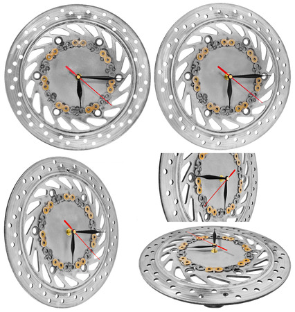 Handmade clock made of motorcycle parts. AHandmade clock made of motorcycle parts, brake disc decorated with hand-painted chain parts. Artistic object on a white background.
 clock face made of a brake disc decorated with hand-painted chain parts. Artistic object on a white background.の写真素材