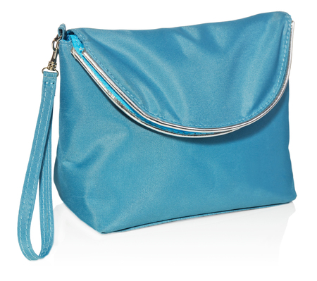 Women's beautician to store cosmetics. Purse for women made of turquoise material with silver borders, space for a logo. Fashionable object isolated on a white background with a slight reflection.の写真素材