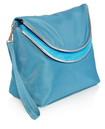Women's beautician to store cosmetics. Purse for women made of turquoise material with silver borders, space for a logo. Fashionable object isolated on a white background with a slight reflection.の写真素材