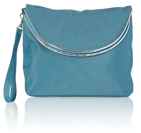 Women's beautician to store cosmetics. Purse for women made of turquoise material with silver borders, space for a logo. Fashionable object isolated on a white background with a slight reflection.の写真素材