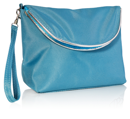 Women's beautician to store cosmetics. Purse for women made of turquoise material with silver borders, space for a logo. Fashionable object isolated on a white background with a slight reflection.の写真素材