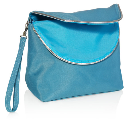 Women's beautician to store cosmetics. Purse for women made of turquoise material with silver borders, space for a logo. Fashionable object isolated on a white background with a slight reflection.の写真素材