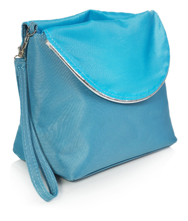 Women's beautician to store cosmetics. Purse for women made of turquoise material with silver borders, space for a logo. Fashionable object isolated on a white background with a slight reflection.の写真素材