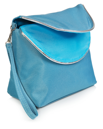 Women's beautician to store cosmetics. Purse for women made of turquoise material with silver borders, space for a logo. Fashionable object isolated on a white background with a slight reflection.の写真素材