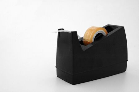 Adhesive roll tape dispenser in a white backgroundの写真素材
