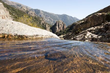 water flowing on a rocky mountainの写真素材