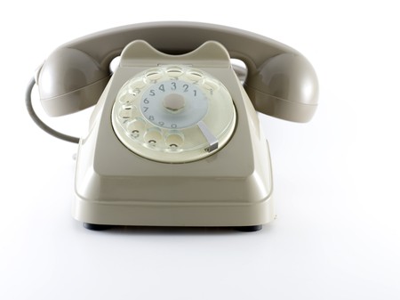 old rotating dial telephon over a white backgroundの写真素材