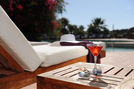 soft drink in a beach chair by the pool of a luxury hotelの写真素材