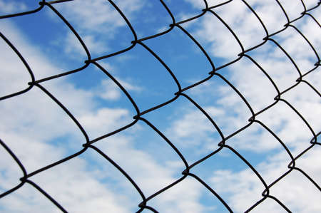 Metallic net with blue sky background