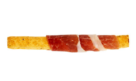 Parma ham prosciutto or spanish jamon with grissini breadsticks isolated on white background.の写真素材