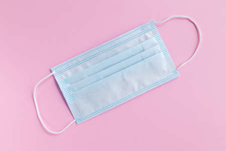 Medical protective face mask, isolated on pink background for protect air pollution or virus. Health...