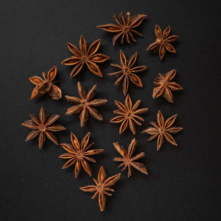 Star anise on the black background, top down view