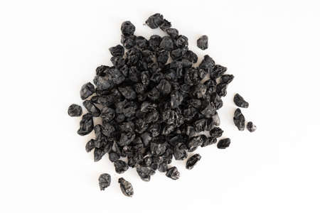 Heap of black raisins isolated on white background. Top view.