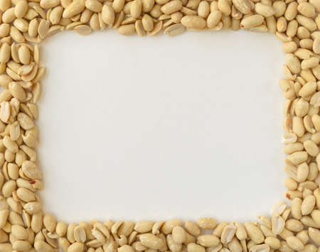Frame made of Peanuts isolated on white background. Composition with peanuts and space for text, top viewの写真素材