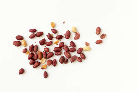 Group of peeled peanuts isolated on a white background, top view.