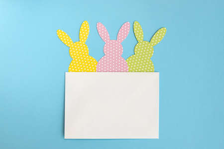 Funny handmade Easter rabbits card. Flat lay. Greeting card template. The minimal concept of Easter.