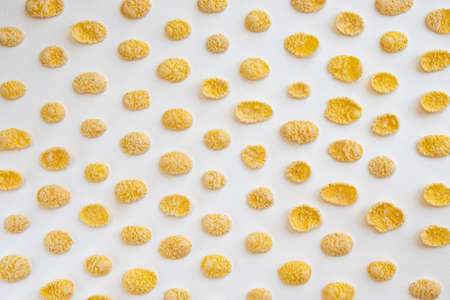 corn flakes isolated on white background, food ingredient, yellow corn cereal for breakfast, heap of...