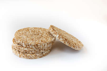 crunchy rice cakes on white background, four puffed whole grain crispbread and empty space for text isolated, close upの写真素材