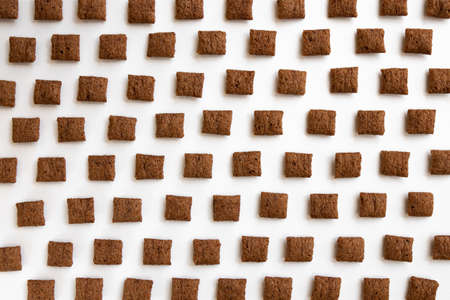 chocolate corn pads isolated on white background, food ingredient, chocolate corn cereal for...