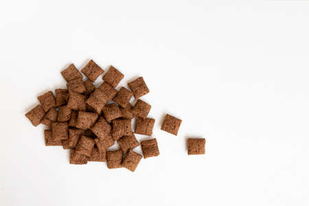 heap of chocolate pads isolated on white background, chocolate corn pads, healthy breakfast, top viewの写真素材