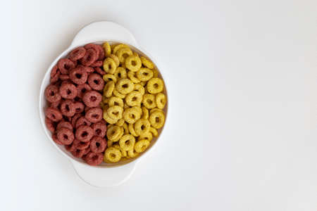 bowl of whole whole grain cereal rings isolated on white background, healthy breakfast concept, plate of delicious ringsの写真素材