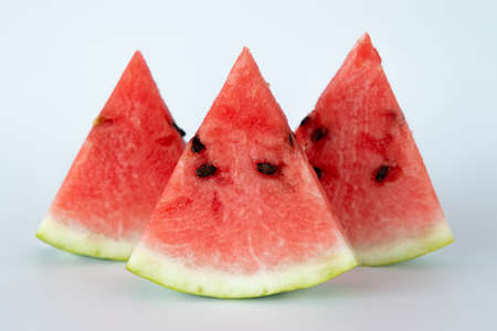 fresh red watermelon slices or pieces and half isolated on white background, side view