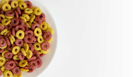 bowl of whole whole grain cereal rings isolated on white background, healthy breakfast concept, plate of delicious rings with empty space for textの写真素材