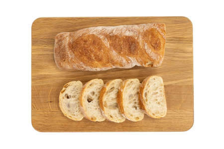 crusty baguette on wooden board isolated on white, cut fresh loaf of bread, dining, dieting,...