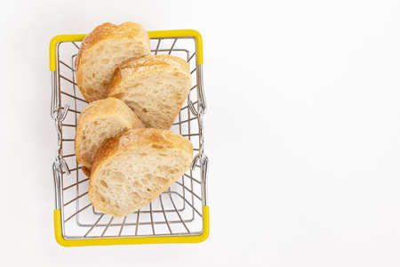 slices of french baguette inshopping basket isolated on white background, top view, concept bakery, sale of breadの写真素材