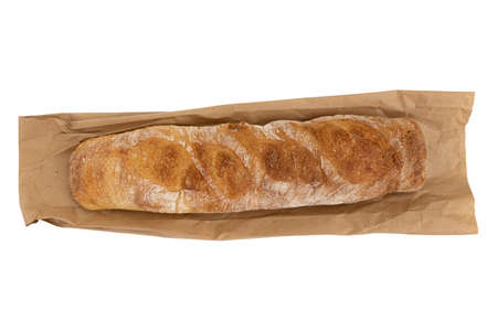 freshly baked delicious bread, whole wheat baguette on paper bag isolated on white background,...