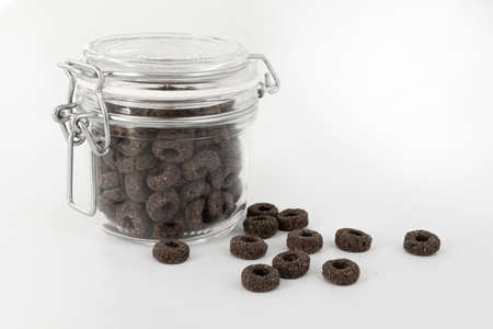 black and cereal rings in glass jar isolated on white background, food ingredient, healthy breakfast, side viewの写真素材