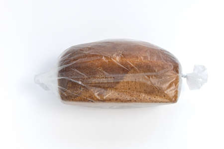 bread in plastic bag, whole loaf in transparent package isolated on white background, top viewの写真素材