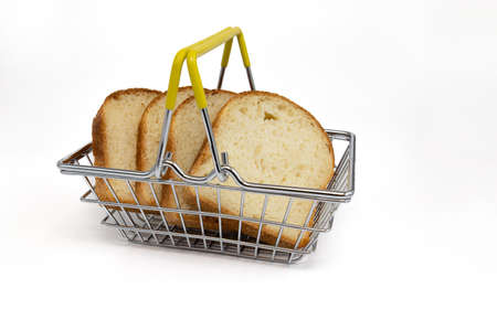 slices wheat bread in steel shopping basket isolated on white background, fresh wheat bread, side...