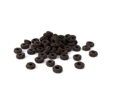 heap of black cereal rings isolated on white background, delicious and useful rings breakfast...