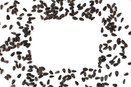 frame of black sunflower seeds with copy space for text isolated on white background, healthy snacks