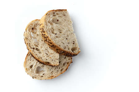 three slices of wheat bread with empty space for text isolated on white background, fresh bread with seeds and linen, top viewの写真素材