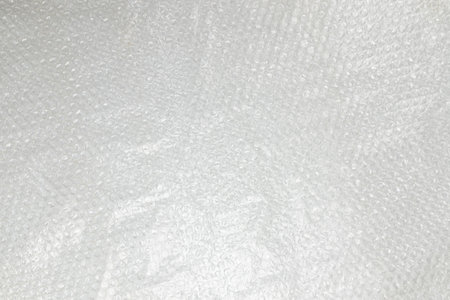 fragment of sheet of plastic transparent packaging film close-up, texture, background of transparent...