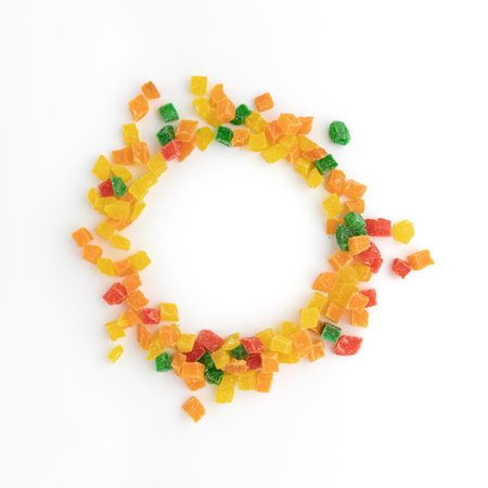 candied fruits, multicolored dried fruits, frame of sweets, candied fruits diced isolated on white...
