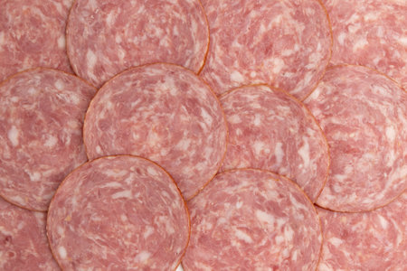 ham slices as background, pieces of sliced ham sausage close up