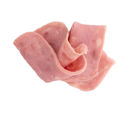 folded slices of boiled ham sausage isolated on white background, pieces of sliced pork ham laid out to create layoutの写真素材