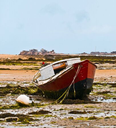 a boat on a low tideの写真素材