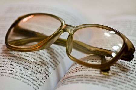 glasses on a bookの写真素材
