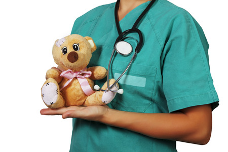 Pediatrician with stethoscope and teddy bearの写真素材