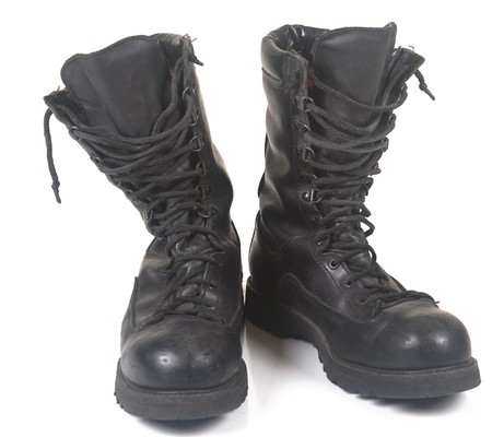 Military black leather boots on a white backgroundの写真素材