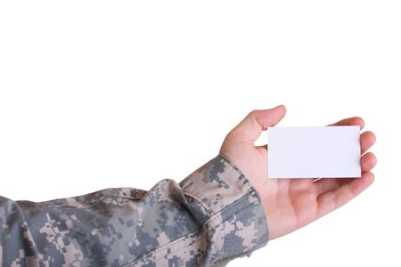 A blank business card held in the hand of a soldier on a white backgroundの写真素材