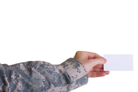 A blank business card held in the hand of a soldier on a white backgroundの写真素材